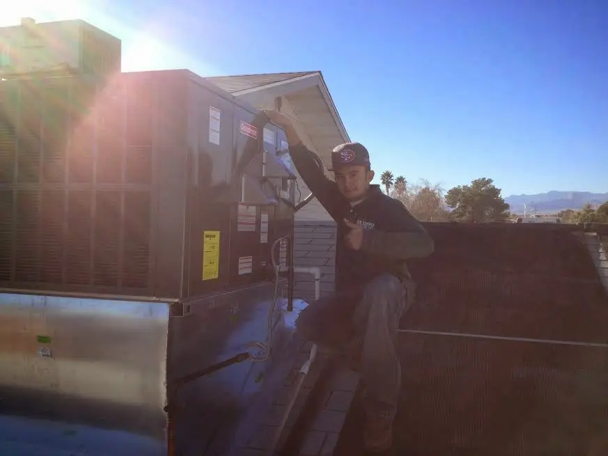 HVAC technician performing HVAC Inspection on a rooftop unit in Rockwood